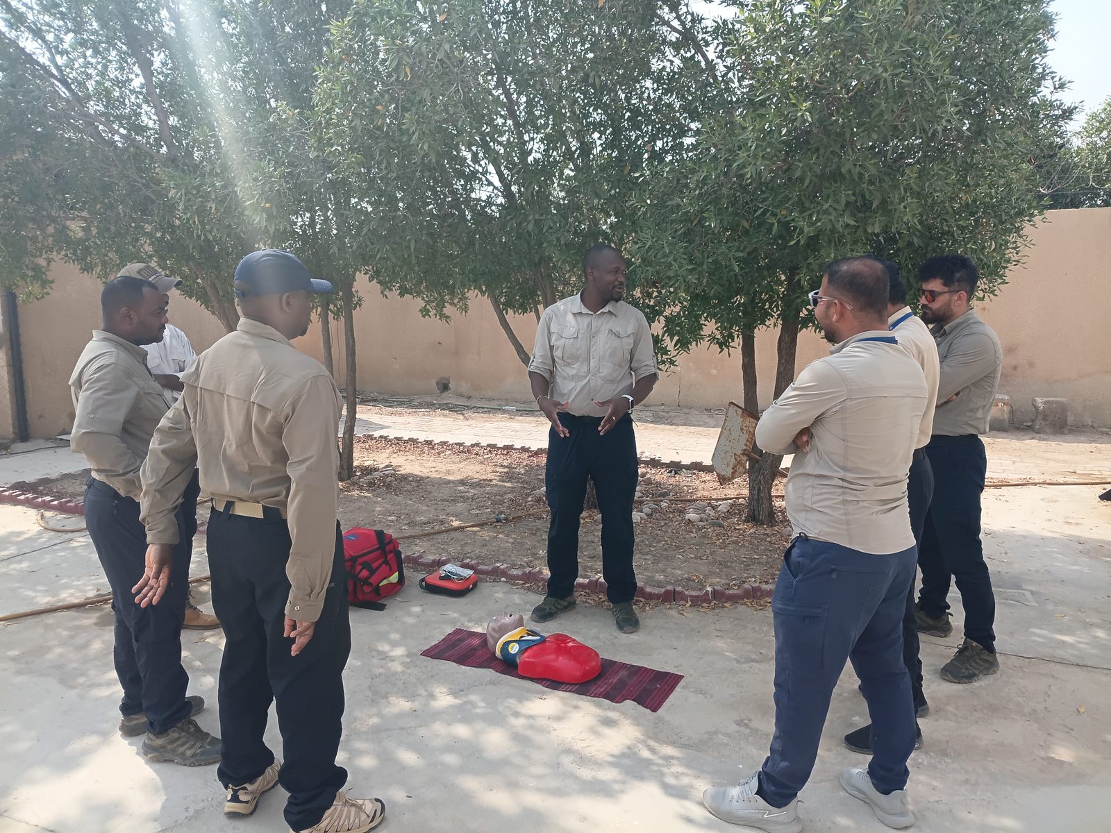 An instructor leads a basic-life-support talk for the team