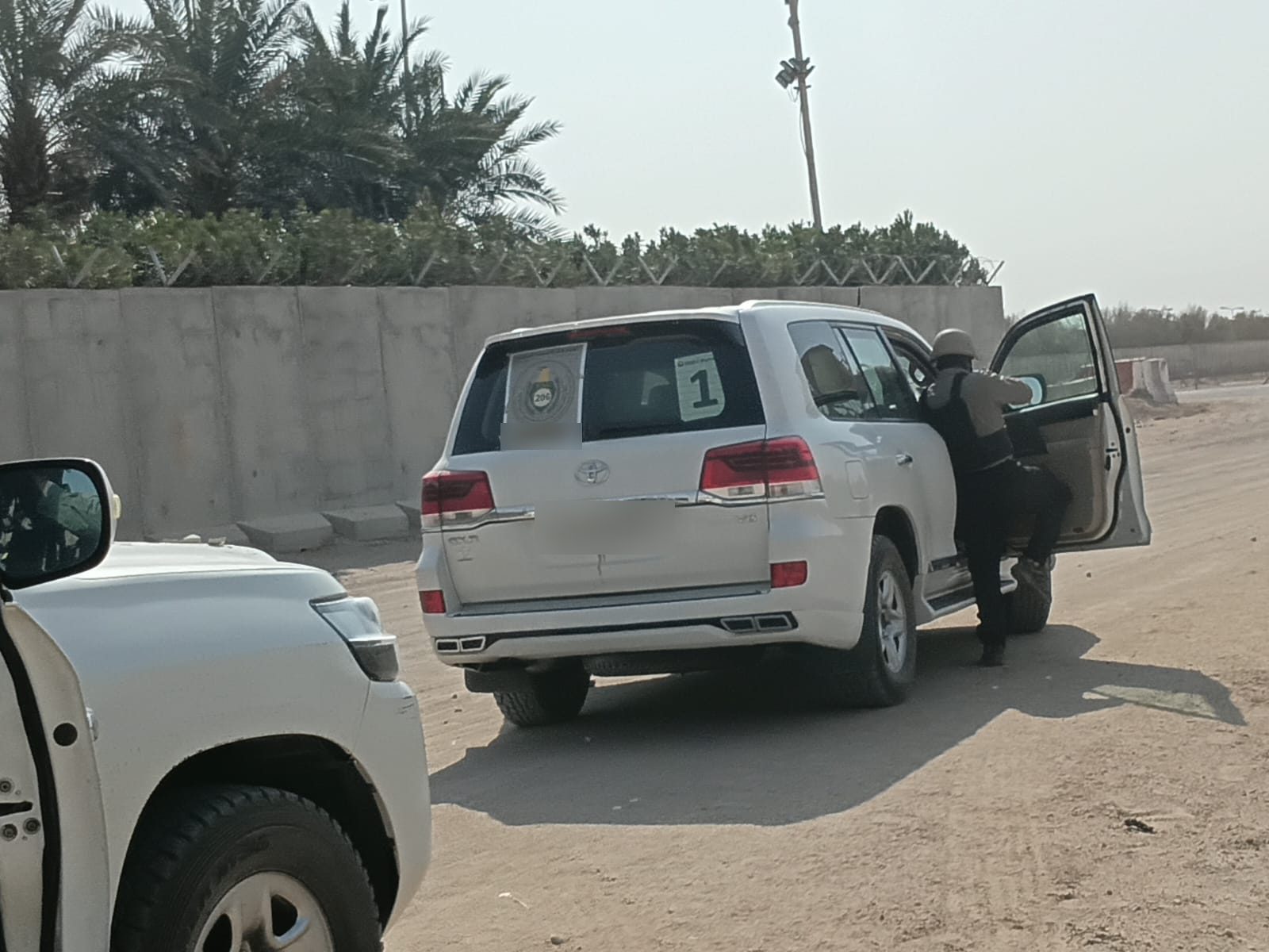 A protective detail member boarding the lead convoy vehicle