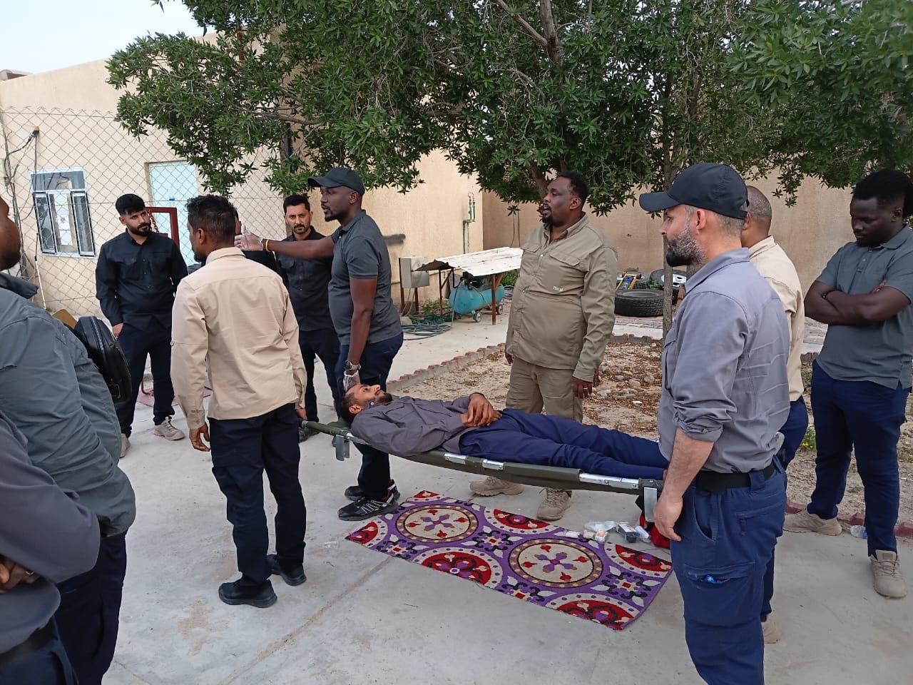 The team lifts a casualty on a stretcher during a drill