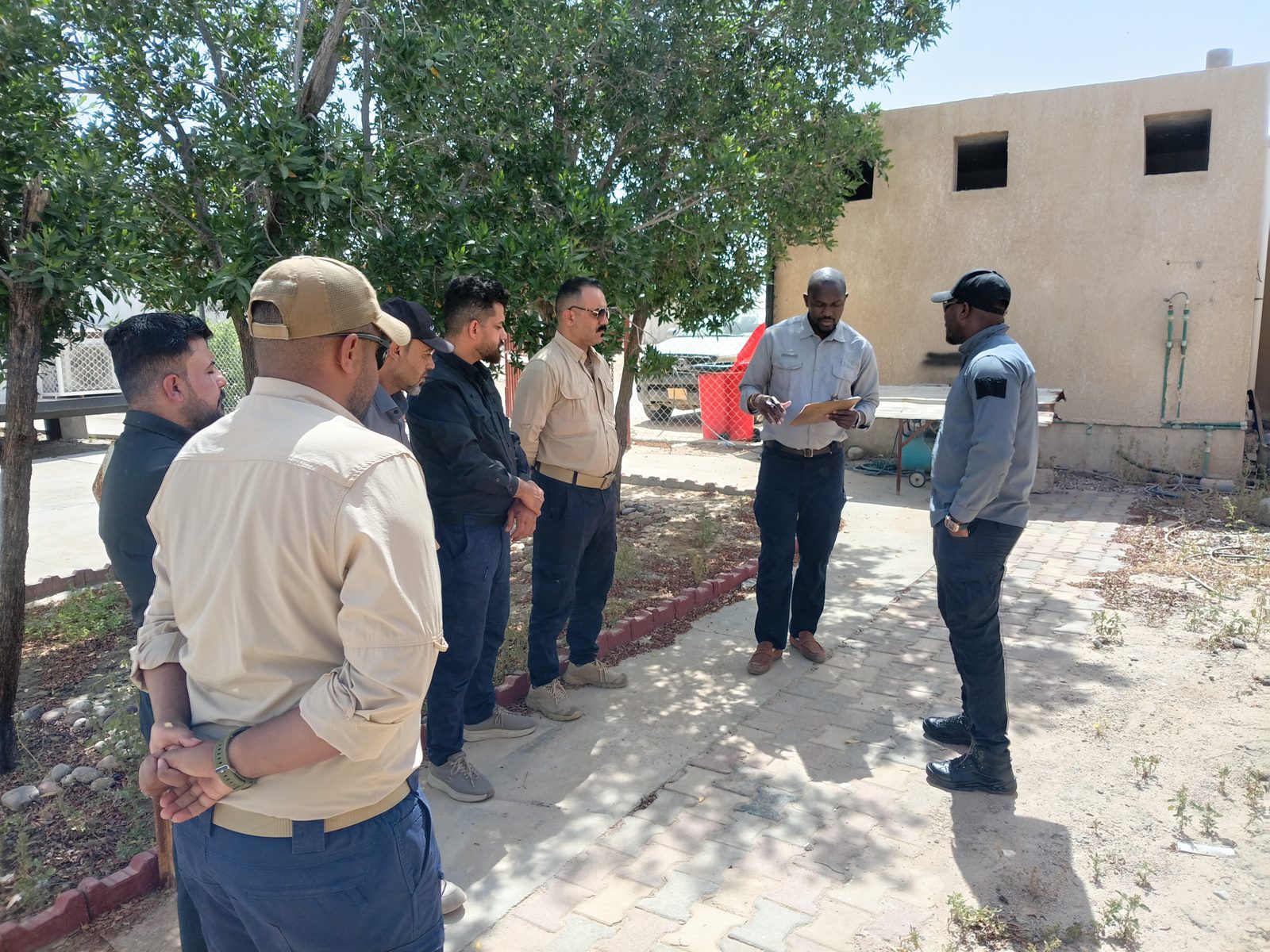 A supervisor gives a short toolbox talk to the guard team