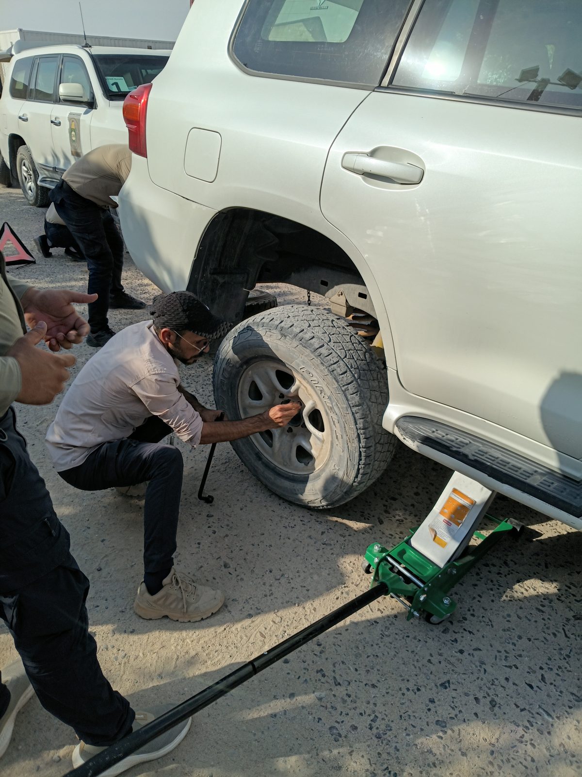 A team member loosens wheel nuts during a vehicle-recovery drill
